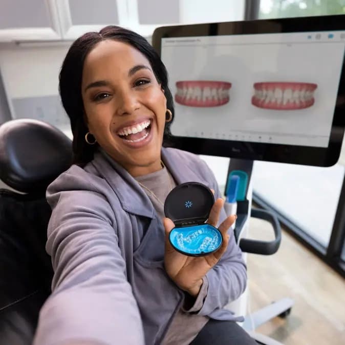 Patient smiling confidently after Invisalign treatment